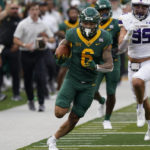Baylor wide receiver Gavin Holmes (6) breaks away from Albany defensive end Anton Juncaj (95) and others to return a punt for a touchdown during the first half of an NCAA college football game in Waco, Texas, Saturday, Sept. 3, 2022. (AP Photo/LM Otero)