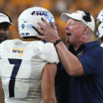 Northern Arizona coach Chris Ball talks to defensive back Morgan Vest (7) during the second half of the team's NCAA college football game against Arizona State, Thursday, Sept. 1, 2022, in Tempe, Ariz. (AP Photo/Rick Scuteri)