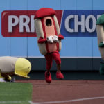 Youngsters dressed as hot dogs compete in the hot dog derby during a baseball game between the Kansas City Royals and the Detroit Tigers Sunday, Sept. 11, 2022, in Kansas City, Mo. (AP Photo/Charlie Riedel)