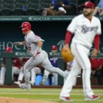
              Los Angeles Angels' Mike Trout, left, sprints down the first base line on his way to a two-run double as Texas Rangers starting pitcher Martin Perez, right, looks to the outfield in the third inning of a baseball game in Arlington, Texas, Thursday, Sept. 22, 2022. (AP Photo/Tony Gutierrez)
            