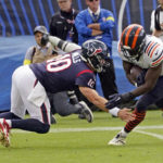 
              Chicago Bears linebacker Roquan Smith, right, is tackled by Houston Texans quarterback Davis Mills (10) after intercepting a pass during the second half of an NFL football game Sunday, Sept. 25, 2022, in Chicago. (AP Photo/Charles Rex Arbogast)
            