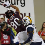 Virginia Tech wide receiver Kaleb Smith (80) hauls in a touchdown pass in front of West Virginia cornerback Wesley McCormick (11) during the first half of an NCAA college football game Thursday, Sept. 22, 2022, in Blacksburg, Va. (AP Photo/Steve Helber)