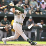 Oakland Athletics' Seth Brown follows through on a solo home run against the Baltimore Orioles in the eighth inning of a baseball game, Sunday, Sept. 4, 2022, in Baltimore. (AP Photo/Gail Burton)