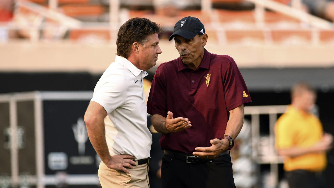 Oklahoma State head coach Mike Gundy, left, and Arizona State head coach Herm Edwards visit prior t...