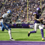
              Minnesota Vikings running back Dalvin Cook (4) scores on a 4-yard touchdown run ahead of Detroit Lions defensive end Demetrius Taylor (52) during the first half of an NFL football game, Sunday, Sept. 25, 2022, in Minneapolis. (AP Photo/Craig Lassig)
            
