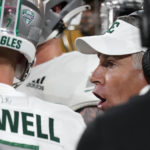 Eastern Michigan coach Chris Creighton talks to players during a timeout in the first half of the team's NCAA college football game against Arizona State on Saturday, Sept. 17, 2022, in Tempe, Ariz. (AP Photo/Darryl Webb)