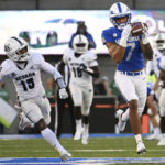 Air Force wide receiver David Cormier (7) catches a pass from quarterback Ben Brittain (not shown) for a touchdown reception as Nevada defensive back Jaden Dedman (15) defends during the first quarter of an NCAA college football game Friday, Sept. 23, 2022, in Air Force Academy, Colo. (Christian Murdock/The Gazette via AP)