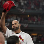 St. Louis Cardinals' Albert Pujols tips his cap after hitting a solo home run during the fourth inning of a baseball game against the Pittsburgh Pirates Friday, Sept. 30, 2022, in St. Louis. (AP Photo/Jeff Roberson)