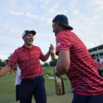 Jordan Spieth, left, and Justin Thomas celebrate after a team win in match play against the International team at the Presidents Cup golf tournament at the Quail Hollow Club, Sunday, Sept. 25, 2022, in Charlotte, N.C. (AP Photo/Julio Cortez)
