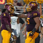 Arizona State quarterback Emory Jones (5) celebrates his touchdown against Eastern Michigan with Des Holmes (75) during the first half of an NCAA college football game Saturday, Sept. 17, 2022, in Tempe, Ariz. (AP Photo/Darryl Webb)