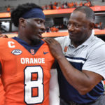 Syracuse head coach Dino Babers, right, celebrates with defensive back Garrett Williams after defeating Purdue in an NCAA college football game in Syracuse, N.Y., Saturday, Sept. 17, 2022. Syracuse won 32-29. (AP Photo/Adrian Kraus)