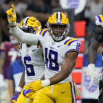 LSU defensive end BJ Ojulari (18) reacts with linebacker Mike Jones Jr. (6) after a defensive stop in the first half of an NCAA college football game against Florida State in New Orleans, Sunday, Sept. 4, 2022. (AP Photo/Gerald Herbert)