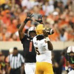 Oklahoma State linebacker Xavier Benson (1) attempts to block a pass by Arizona State quarterback Emory Jones (5) during the first half of an NCAA college football game Saturday, Sept. 10, 2022, in Stillwater, Okla. (AP Photo/Brody Schmidt)