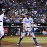 Los Angeles Dodgers' Chris Taylor (3) reacts to being called out on strikes as Arizona Diamondbacks catcher Carson Kelly (18) throws the ball to a teammate during the third inning of a baseball game in Phoenix, Tuesday, Sept. 13, 2022. (AP Photo/Ross D. Franklin)
