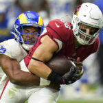 Los Angeles Rams linebacker Justin Hollins (58) tackles Arizona Cardinals tight end Zach Ertz (86) after Ertz made a catch during the first half of an NFL football game, Sunday, Sept. 25, 2022, in Glendale, Ariz. (AP Photo/Ross D. Franklin)