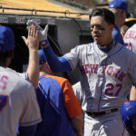 New York Mets' Mark Vientos high-fives teammates in the dugout after hitting a solo home run against the Oakland Athletics during the second inning of a baseball game in Oakland, Calif., Saturday, Sept. 24, 2022. (AP Photo/Tony Avelar)