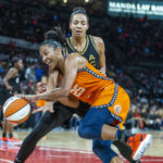 Connecticut Sun forward Alyssa Thomas (25) battles on the dribble inside with Las Vegas Aces center Kiah Stokes, top, during the second half in Game 1 of a WNBA basketball final playoff series Sunday, Sept. 11, 2022, in Las Vegas. (AP Photo/L.E. Baskow)