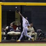 Milwaukee Brewers left fielder Andrew McCutchen catches a fly ball hit by Arizona Diamondbacks' Josh Rojas during the sixth inning of a baseball game Friday, Sept. 2, 2022, in Phoenix. (AP Photo/Ross D. Franklin)