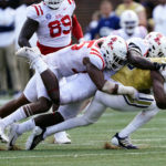 Georgia Tech quarterback Jeff Sims (10) is sacked by Mississippi defensive end Tavius Robinson (95) in the first half of an NCAA college football game, Saturday, Sept. 17, 2022, in Atlanta. (AP Photo/John Bazemore)