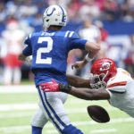 Indianapolis Colts quarterback Matt Ryan (2) fumbles as he is hit by Kansas City Chiefs defensive end Carlos Dunlap (8) during the first half of an NFL football game, Sunday, Sept. 25, 2022, in Indianapolis. (AP Photo/AJ Mast)