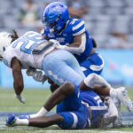 Georgia State linebacker Jacorey Crawford and safety Antavious Lane tackles North Carolina running back D.J. Jones in the second half of an NCAA college football game against Saturday, Sept. 10, 2022, in Atlanta. (AP Photo/Hakim Wright Sr.)