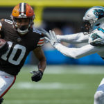 
              Cleveland Browns wide receiver Anthony Schwartz runs around Carolina Panthers safety Xavier Woods during the second half of an NFL football game on Sunday, Sept. 11, 2022, in Charlotte, N.C. (AP Photo/Rusty Jones)
            