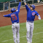 Chicago Cubs' Patrick Wisdom, right, celebrates with third base coach Willie Harris (33) as he rounds third after hitting a three-run home run off Pittsburgh Pirates relief pitcher Manny Banuelos during the fifth inning of a baseball game in Pittsburgh, Sunday, Sept. 25, 2022. (AP Photo/Gene J. Puskar)