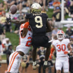 
              Wake Forest wide receiver A.T. Perry (9) misses a catch as he is hit by Clemson cornerback Nate Wiggins (20) during the first half of an NCAA college football game in Winston-Salem, N.C., Saturday, Sept. 24, 2022. Wiggins was called for pass interference on the play. (AP Photo/Chuck Burton)
            