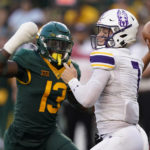 
              Albany quarterback Reese Poffenbarger (7) passes under pressure from Baylor safety Al Walcott (13) during the first half of an NCAA college football game in Waco, Texas, Saturday, Sept. 3, 2022. (AP Photo/LM Otero)
            