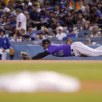 Colorado Rockies first baseman Elehuris Montero can't get to a ball hit for a single by Los Angeles Dodgers' Cody Bellinger during the seventh inning of a baseball game Friday, Sept. 30, 2022, in Los Angeles. (AP Photo/Mark J. Terrill)