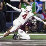 
              Texas A&M wide receiver Evan Stewart (1) catches a pass for a touchdown as Arkansas defensive back Malik Chavis (4) defends during the first half of an NCAA college football game Saturday, Sept. 24, 2022, in Arlington, Texas. (AP Photo/Brandon Wade)
            