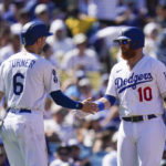 
              Los Angeles Dodgers' Trea Turner, left, and Justin Turner shake hands after Trea Turner scored on a single hit by Will Smith during the second inning of a baseball game against the St. Louis Cardinals Sunday, Sept. 25, 2022, in Los Angeles. (AP Photo/Jae C. Hong)
            