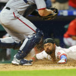 
              Philadelphia Phillies' Edmundo Sosa, right, slides into home on a double by Brandon Marsh as Washington Nationals catcher Riley Adams, left, waits for the ball during the fourth inning of a baseball game, Saturday, Sept. 10, 2022, in Philadelphia. (AP Photo/Chris Szagola)
            