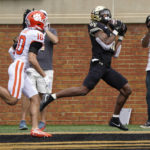 Wake Forest wide receiver Donavon Greene (11) catches a touchdown pass ahead of Clemson cornerback Jeadyn Lukus (10) during the second half of an NCAA college football game in Winston-Salem, N.C., Saturday, Sept. 24, 2022. (AP Photo/Chuck Burton)