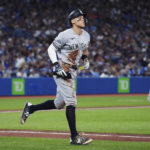 New York Yankees' Aaron Judge jogs to first base after being walked by Toronto Blue Jays relief pitcher Zach Pop during the sixth inning of a baseball game Tuesday, Sept. 27, 2022, in Toronto. (Nathan Denette/The Canadian Press via AP)