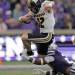 
              Missouri quarterback Brady Cook (12) is tackled by Kansas State safety Kobe Savage (2) during the first half of an NCAA college football game Saturday, Sept. 10, 2022, in Manhattan, Kan. (AP Photo/Charlie Riedel)
            