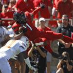 Texas' Anthony Cook (11) tackles Texas Tech's Myles Price (1) during the first half of an NCAA college football game Saturday, Sept. 24, 2022, in Lubbock, Texas. (AP Photo/Brad Tollefson)