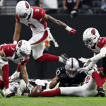 
              Arizona Cardinals cornerback Byron Murphy Jr., left, picks up a fumble and returns it for the winning touchdown during overtime of an NFL football game against the Las Vegas Raiders, Sunday, Sept. 18, 2022, in Las Vegas. (AP Photo/David Becker)
            