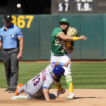 Oakland Athletics second baseman Jordan Diaz, top right, forces out New York Mets' Luis Guillorme, bottom right, as he throws to first base to turn a double play during the fourth inning of a baseball game in Oakland, Calif., Saturday, Sept. 24, 2022. (AP Photo/Tony Avelar)