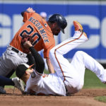 
              Houston Astros' Chas McCormick is tagged out by Baltimore Orioles second baseman Rougned Odor on a steal attempt in the third inning of a baseball game, Sunday, Sept. 25, 2022, in Baltimore. (AP Photo/Gail Burton)
            