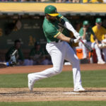 Oakland Athletics' Dermis Garcia hits a double to drive in two runs against the New York Mets during the first inning of a baseball game in Oakland, Calif., Saturday, Sept. 24, 2022. (AP Photo/Tony Avelar)