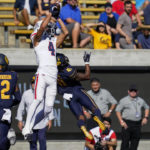 
              Arizona wide receiver Tetairoa McMillan (4) catches a 24-yard touchdown over California cornerback Isaiah Young (41) during the first half of an NCAA college football game in Berkeley, Calif., Saturday, Sept. 24, 2022. (AP Photo/Godofredo A. Vásquez)
            