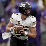 
              Missouri quarterback Brady Cook looks to pass during the first half of an NCAA college football game against Kansas State Saturday, Sept. 10, 2022, in Manhattan, Kan. (AP Photo/Charlie Riedel)
            