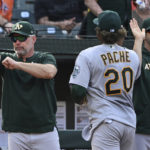 
              Oakland Athletics manager Mark Kotsay, left, gives a thumbs-up after defeating the Baltimore Orioles in a baseball game, Sunday, Sept. 4, 2022, in Baltimore. (AP Photo/Gail Burton)
            