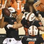 Oklahoma State wide receiver Bryson Green (9) celebrates with fullback Braden Cassity (90) after scoring a touchdown during the second half of an NCAA college football game Saturday, Sept. 10, 2022, in Stillwater, Okla. (AP Photo/Brody Schmidt)