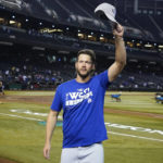 Los Angeles Dodgers starting pitcher Clayton Kershaw waves to Dodgers fans after the team's 4-0 win in a baseball game against the Arizona Diamondbacks in Phoenix, Tuesday, Sept. 13, 2022. The Dodgers clinched the National League West. (AP Photo/Ross D. Franklin)