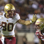 
              Boston College tight end George Takacs (80) runs the ball after a catch and stiff-arms Florida State defensive back Akeem Dent (27) during the third quarter of an NCAA college football game on Saturday, Sept. 24, 2022, in Tallahassee, Fla. (AP Photo/Gary McCullough)
            
