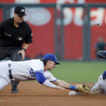 
              Seattle Mariners' Ty France (23) is safe with a double as Kansas City Royals shortstop Bobby Witt Jr. (7) is too late reaching for the tag during the first inning of a baseball game in Kansas City, Mo., Saturday, Sept. 24, 2022. Making the call is umpire Ryan Blakney. (AP Photo/Colin E. Braley)
            