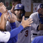 
              Los Angeles Dodgers' Chris Taylor is congratulated by teammates in the dugout after scoring on a double by Mookie Betts during the second inning of a baseball game against the Colorado Rockies Friday, Sept. 30, 2022, in Los Angeles. (AP Photo/Mark J. Terrill)
            