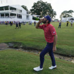 Max Homa drinks champagne after the USA team defeated the International team in match play at the Presidents Cup golf tournament at the Quail Hollow Club, Sunday, Sept. 25, 2022, in Charlotte, N.C. (AP Photo/Julio Cortez)